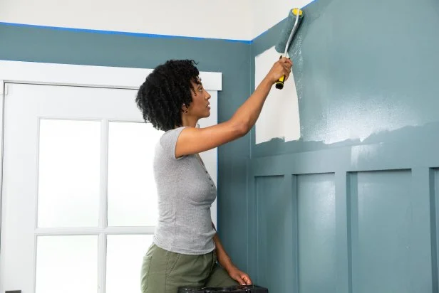 The next step in this DIY accent wall project is to paint the area above the trim with Riverway from HGTV Home by Sherwin Williams.